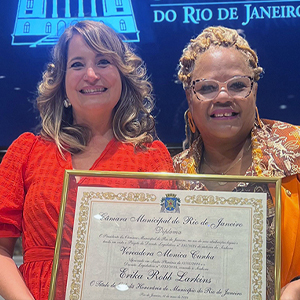 two women hold award