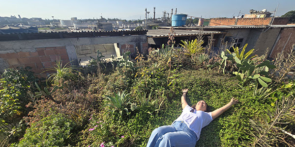 woman lays on mound of greenery