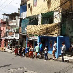people waiting in long line in the favela